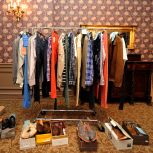 Various outfits lined up for the celebrity models in the dressing room.